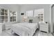 Bright bedroom with a queen-size bed and white furniture at 115 Burns Rd, Terra Ceia, FL 34250