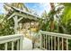 Charming deck overlooks lush landscaping and leads to a gazebo at 115 Burns Rd, Terra Ceia, FL 34250