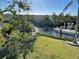 Waterfront property featuring a private dock with a boat, lush greenery, and serene water views at 115 Burns Rd, Terra Ceia, FL 34250