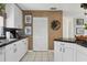 White kitchen with ample counter space and a built-in pantry at 115 Burns Rd, Terra Ceia, FL 34250