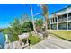 Waterfront view from the dock with lush landscaping, showcasing the home's serene waterfront location with a convenient workstation at 115 Burns Rd, Terra Ceia, FL 34250