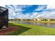 Backyard with canal view and lush green grass at 12563 Felice Dr, Venice, FL 34293