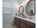 Modern bathroom with double vanity and decorative mirrors at 13013 Ramblewood Trl, Bradenton, FL 34211