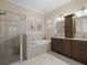 Elegant bathroom with double vanity, soaking tub, and shower at 13013 Ramblewood Trl, Bradenton, FL 34211