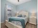 Charming bedroom with a queen-size bed and light blue walls at 13013 Ramblewood Trl, Bradenton, FL 34211