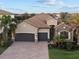 Two-story house with tile roof and two-car garage at 13013 Ramblewood Trl, Bradenton, FL 34211