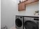 Laundry room with LG washer and dryer and additional cabinets at 13013 Ramblewood Trl, Bradenton, FL 34211