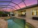 Relaxing kidney-shaped pool and spa with screened enclosure at 13013 Ramblewood Trl, Bradenton, FL 34211