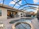 Resort-style pool and spa with covered patio and outdoor kitchen at 13013 Ramblewood Trl, Bradenton, FL 34211