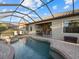 Inviting pool and spa with screened enclosure and access to interior living space at 13013 Ramblewood Trl, Bradenton, FL 34211