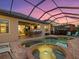 Relaxing kidney-shaped pool and spa with screened enclosure at 13013 Ramblewood Trl, Bradenton, FL 34211