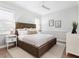 Inviting bedroom with a woven headboard, ceiling fan, neutral tones, and ample natural light from the windows at 1519 Harbor Dr, Sarasota, FL 34239