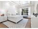 Bright, airy bedroom featuring a large window, white furniture and a patterned area rug at 1519 Harbor Dr, Sarasota, FL 34239