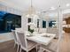 Dining room featuring modern chandelier, white table setting, and mirrored wall at 1519 Harbor Dr, Sarasota, FL 34239