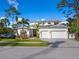 Beautiful two-story home featuring manicured lawn, mature palm trees, and a three-car garage at 1519 Harbor Dr, Sarasota, FL 34239