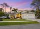 Attractive home exterior with a lush front lawn, complemented by mature palm trees at 1519 Harbor Dr, Sarasota, FL 34239