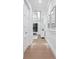 Bright hallway with hardwood floors, white trim, and recessed lighting at 1519 Harbor Dr, Sarasota, FL 34239