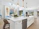 Bright kitchen with a center island featuring bar stool seating and stainless steel dishwasher at 1519 Harbor Dr, Sarasota, FL 34239