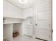 Clean laundry room with white cabinets, countertop space, a sink, and hexagon tile floors at 1519 Harbor Dr, Sarasota, FL 34239