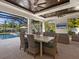 Inviting outdoor dining space with a pool view, wicker chairs and a summer kitchen at 1519 Harbor Dr, Sarasota, FL 34239