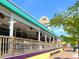 Outdoor seating at a vibrant restaurant with a wooden railing and colorful awnings at 1519 Harbor Dr, Sarasota, FL 34239