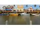 Waterfront view of colorful beach houses and boats docked along a canal on a sunny day at 1519 Harbor Dr, Sarasota, FL 34239