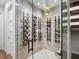 Stylish wine cellar featuring brick walls, herringbone tile flooring, glass doors and custom wine racks at 1519 Harbor Dr, Sarasota, FL 34239