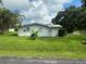 White house with lush green lawn at 1703 Center Rd, Terra Ceia, FL 34250