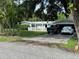 Ranch-style home with carport and fenced yard at 1703 Center Rd, Terra Ceia, FL 34250