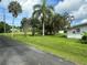 Residential street with tropical landscaping and houses at 1703 Center Rd, Terra Ceia, FL 34250