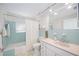 Bathroom featuring stylish turquoise tiling, shower, modern white vanity and fixtures at 1716 Forest Rd, Venice, FL 34293