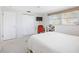 Well-lit bedroom featuring white door, closet, modern ceiling fan and a dedicated desk area with a red chair at 1716 Forest Rd, Venice, FL 34293