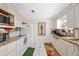 Kitchen with white appliances, patterned countertops, and tile flooring provides a cozy and functional cooking space at 1716 Forest Rd, Venice, FL 34293