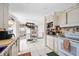 Spacious kitchen with white cabinetry, stainless steel appliances, and a view into the laundry room at 1716 Forest Rd, Venice, FL 34293