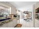 Bright kitchen featuring white cabinetry, stainless steel appliances, and patterned countertops at 1716 Forest Rd, Venice, FL 34293