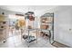 Bright kitchen with tile flooring, stainless steel island, hanging pot rack, and decorative shelving at 1716 Forest Rd, Venice, FL 34293