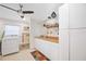 Well-lit laundry room features a utility sink, white cabinets, and a modern washer and dryer for convenience at 1716 Forest Rd, Venice, FL 34293