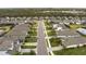 Aerial view of a neighborhood with houses and a pond at 1925 146Th E Ter, Parrish, FL 34219