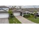 Aerial view of a gray house with landscaping and driveway at 1925 146Th E Ter, Parrish, FL 34219