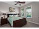 Bedroom with wooden sleigh bed and window seating at 1925 146Th E Ter, Parrish, FL 34219