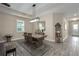 Formal dining room with rustic table and chandelier, view of entryway at 1925 146Th E Ter, Parrish, FL 34219