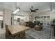 Open concept dining area with wooden table, chandelier and view into living room at 1925 146Th E Ter, Parrish, FL 34219