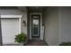 Inviting front entry with dark blue door, welcome sign, and sidelights at 1925 146Th E Ter, Parrish, FL 34219