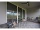 Cozy covered porch with seating area and sliding glass doors at 1925 146Th E Ter, Parrish, FL 34219