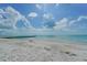 Scenic beach view with clear water and blue sky at 2295 Gulf Of Mexico Dr # 115S, Longboat Key, FL 34228