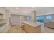 Modern kitchen with open layout to living room and water views at 2295 Gulf Of Mexico Dr # 115S, Longboat Key, FL 34228