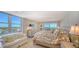 Bright bedroom with water views and ensuite bath at 2295 Gulf Of Mexico Dr # 115S, Longboat Key, FL 34228