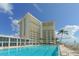 Resort-style pool with lounge chairs and ocean view at 2295 Gulf Of Mexico Dr # 115S, Longboat Key, FL 34228