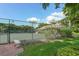 Well-maintained tennis court with surrounding greenery at 2295 Gulf Of Mexico Dr # 115S, Longboat Key, FL 34228