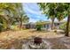 Large backyard with fire pit and tropical landscaping at 2503 Bispham Rd, Sarasota, FL 34231